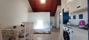 a kitchen with a table and a bed in a room at Penthouse with Terrace in Santa Maria Ca Firenze Sal Service in Santa Maria