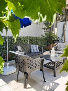 a patio with chairs and a table and a couch at Apartment Marina in Kotor