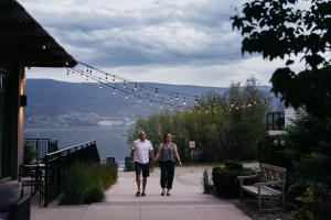 a man and a woman walking across a bridge at Summerland Waterfront Resort & Spa in Summerland