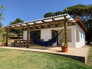 a patio with a hammock and a house at Lostpoint Home in Monte Alto