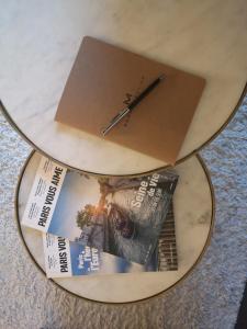 a book and a clock on a table at Happy Place - 15 min Paris & 30 min DisneyLand - Subways - Facilities - Free parking - Secured in Maisons-Alfort