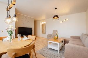 a living room with a table and a couch at Kuuse 4 Apartment with 2 bedrooms in Haapsalu