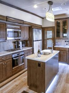 a large kitchen with wooden cabinets and a sink at H - Driftwood in Fort Bragg