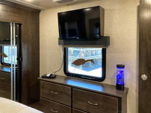 a bedroom with a tv with a bird in a fish tank at H - Driftwood in Fort Bragg