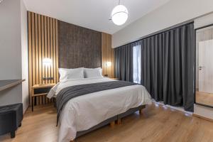 a bedroom with a large bed and a large window at Ethereal Athεns in Athens