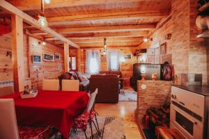 a living room with a table with a red table cloth at Momo's House in Žabljak