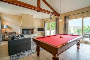 a pool table in a living room with a fireplace at Le Mas de Sevrier in Sévrier