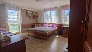 a bedroom with a bed and a table and windows at Baltazar in Łeba +60 photos