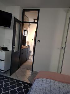 a bedroom with a door open to a kitchen with a bed at A place to relax in Ljubljana