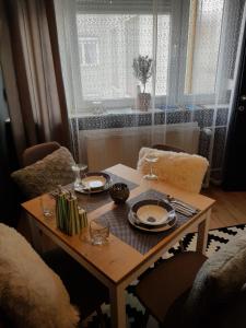 a table with plates and glasses on top of it at A place to relax in Ljubljana