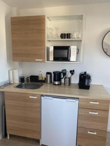 a kitchen with a white refrigerator and a microwave at Privates neu renoviertes Zimmer in Schwaig in Schwaig bei Nürnberg