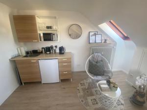 a small kitchen with a table and a white refrigerator at Privates neu renoviertes Zimmer in Schwaig in Schwaig bei Nürnberg