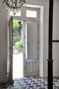 an open door in a room with a chandelier at Château du Roc in Saint-Thomas-de-Cônac