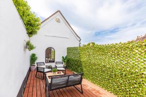 an outdoor patio with chairs and a fence at Sleep 10- The Lovely Lymington Lock off. in Lymington