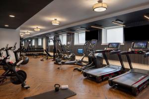 a gym with several treadmills and cardio machines at Beacon Grand, A Union Square Hotel in San Francisco