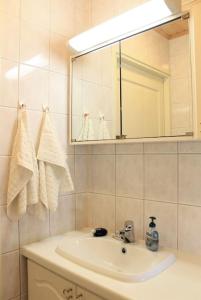 een badkamer met een wastafel en een spiegel bij Albertiina in Kurikka