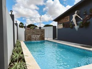 a swimming pool in the backyard of a house at Aruba Bliss Condos in Oranjestad