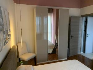 a room with a mirror and a couch and a bedroom at La Favola Apartment Orbassano in Orbassano