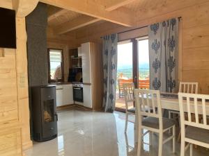a kitchen with a fireplace and a table and chairs at Osada pod Giewontem 3 - KACPROWY in Czerwienne