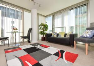 uma sala de estar com um sofá e uma mesa em Central Hub Apartment with Balcony, Fast Wifi, Smart TV and Free Parking em Milton Keynes