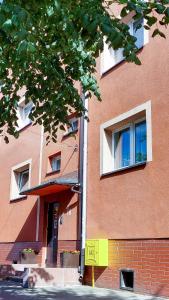 a tall brick building with windows on the side of it at Casa in Centro Apartments and more in Łeba