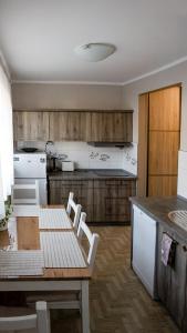 a kitchen with a table and chairs in a kitchen at Casa in Centro Apartments and more in Łeba