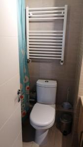 a bathroom with a white toilet and a heater at DEPARTAMENTOS TERMAS DE CHILLAN in Nevados de Chillan