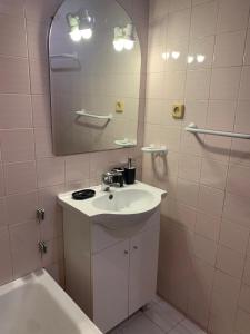 a bathroom with a sink and a mirror at Casa da Universidade in Coimbra