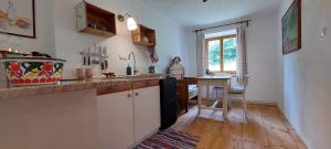 a kitchen with a sink and a desk in it at Graslandhof in Neumarkt in Steiermark