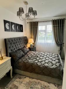 a bedroom with a bed and a large window at Lovely Apartment in Castlebar in Castlebar