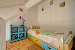 a childs bedroom with a bed and a blue cabinet at Crystal Beach, vue mer, accès direct plage et piscine, clim in Sèze +25 photos