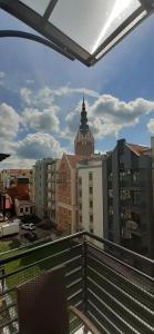 a view of a city from a balcony at Oasis, Old Town Apartment in Elblag