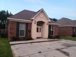 a red brick house with a white door at Villa 7 in Hammond