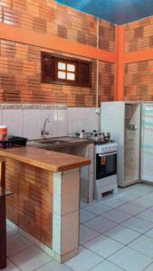 a kitchen with a sink and a stove at Chale Praia Residence in São Luís