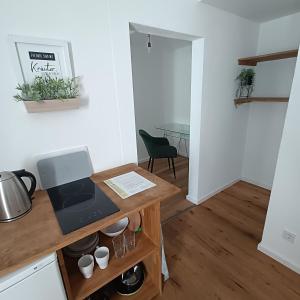 uma cozinha com uma mesa com um computador portátil em Apartments & möblierte Zimmer in Kahl am Main, kontaktloser Self Check-in, W-Lan, Schreibtisch, Duschbad, Küchenzeile, PKW-Plätze em Kahl am Main