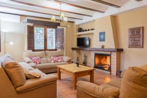 a living room with two couches and a fireplace at Casas rurales Camaretas in Yeste