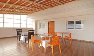 a dining room with tables and chairs in a room at Treebo Trend Krishnam Boutique in Bangalore
