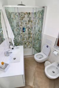 a bathroom with a shower and a toilet and a sink at Guest House Rione Cappuccini in Sant'Agnello