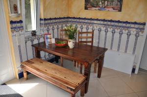 a wooden table with a bench and a table and chair at Casa del Sol in Schwielowsee