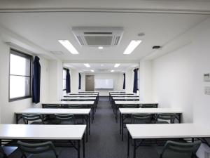 an empty classroom with white tables and chairs at Az Inn Fukui - Vacation STAY 65942v in Fukui +33 photos