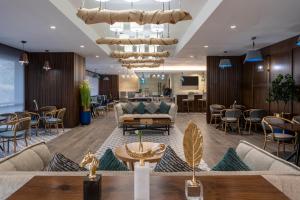 a lobby with a couch and chairs and a table at Novotel Makkah Thakher City in Makkah