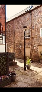 a street light in front of a brick building at Courtyard Holiday Apartments in Belper