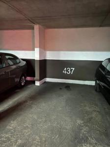 a parking garage with two cars parked in it at Grato y céntrico depto entre Providencia y Ñuñoa in Santiago