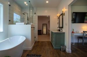 a bathroom with a tub and a sink at Brackens View Retreat in Marshall