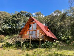 a log cabin with a red roof at BRUMA BLANCA CHALETS in Medellín