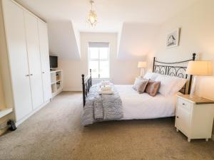 a bedroom with a bed and a television in it at Stillwaters in Bushmills
