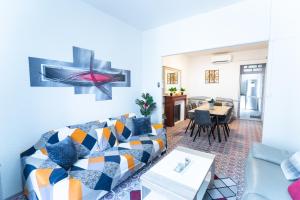 a living room with a couch and a table at Appartement Les Halles , Climatisation, Terrasse, Garage in Narbonne
