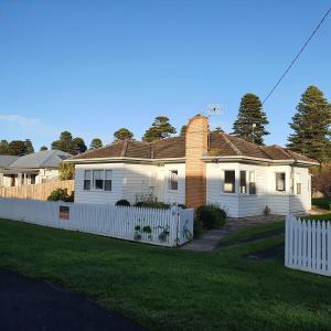 a white house with a white picket fence at Mary Grant in Port Fairy