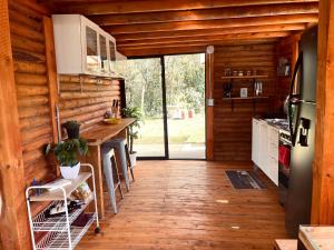 a kitchen with wooden walls and a wooden floor at BRUMA BLANCA CHALETS in Medellín
