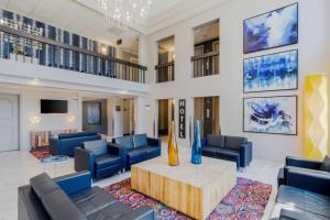 a living room with blue chairs and a table at Best Western St Louis Kirkwood Route 66 in Saint Louis